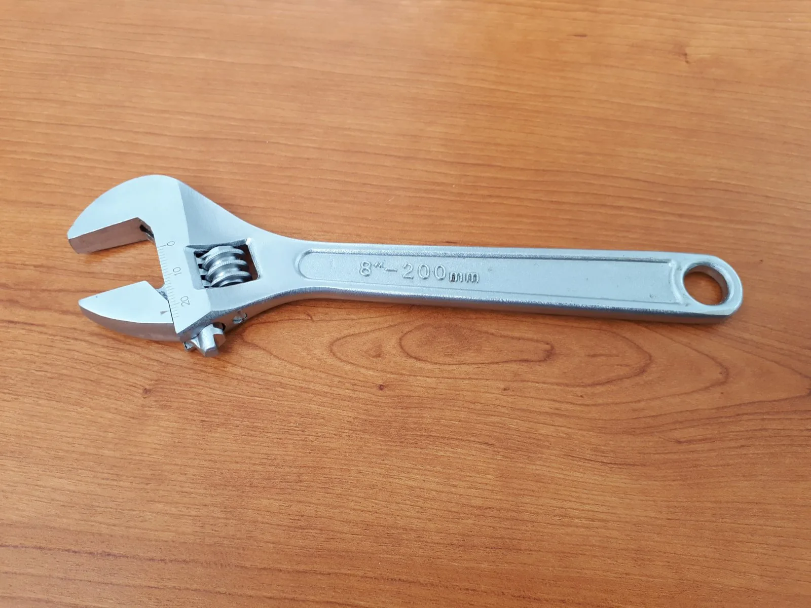 A large adjustable wrench open and ready to use